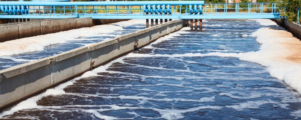 Wastewater is aerated for microbial treatment, settled to remove solids, disinfected, and then dewatered. The resulting sludge can be disposed of, composted, or used in agriculture.