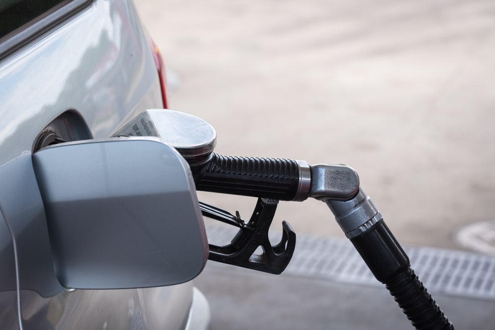 Pumping gasoline fuel in car at gas station