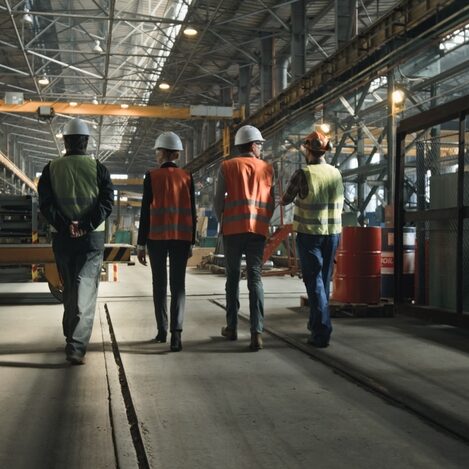 Back,View,Of,Four,Heavy,Industry,Technicians,In,Uniform,And Back view of four heavy industry technicians in uniform